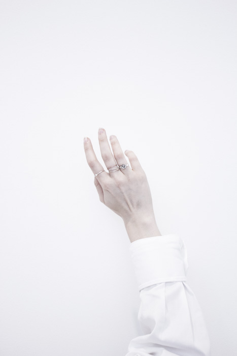 An arm in white shirt against a pure white background