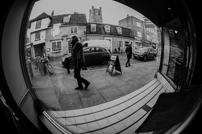 A black and white image of a street scene, shot using ultra Wide Angle focal length 