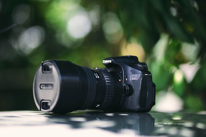 A Canon DSLR camera resting on a table outdoors
