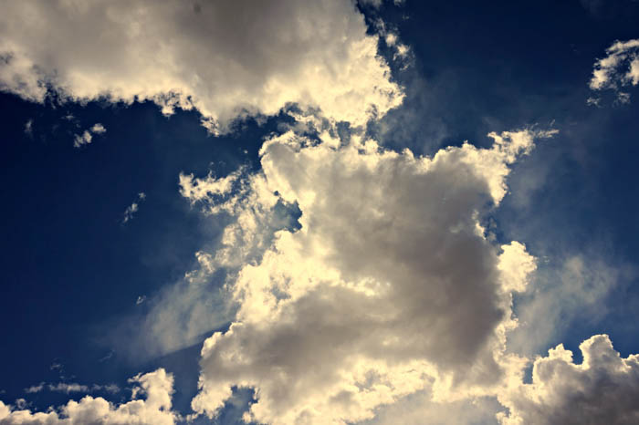 a photo of cumulus clouds against a blue sky