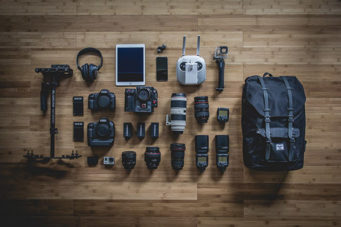 A flat lay of various photography equipment