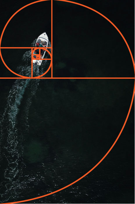 An aerial photo of a boat at sea with the golden ratio grid overlayed - golden ratio vs rule of thirds