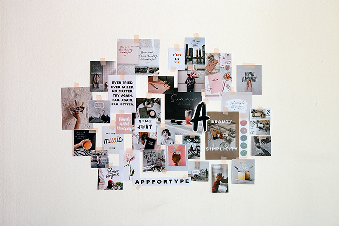 different photos and text taped to a wall as inspiration for finding photography style 