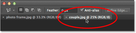 Switching between images in Photoshop by clicking the document tabs.